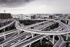 skyline and traffic trails on highway intersection